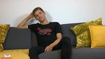 He climbs up on the sofa, sits down on the back of it and spreads his legs.  Dylan starts jacking his cock again and his huge nuts bounce up and down with every stroke.